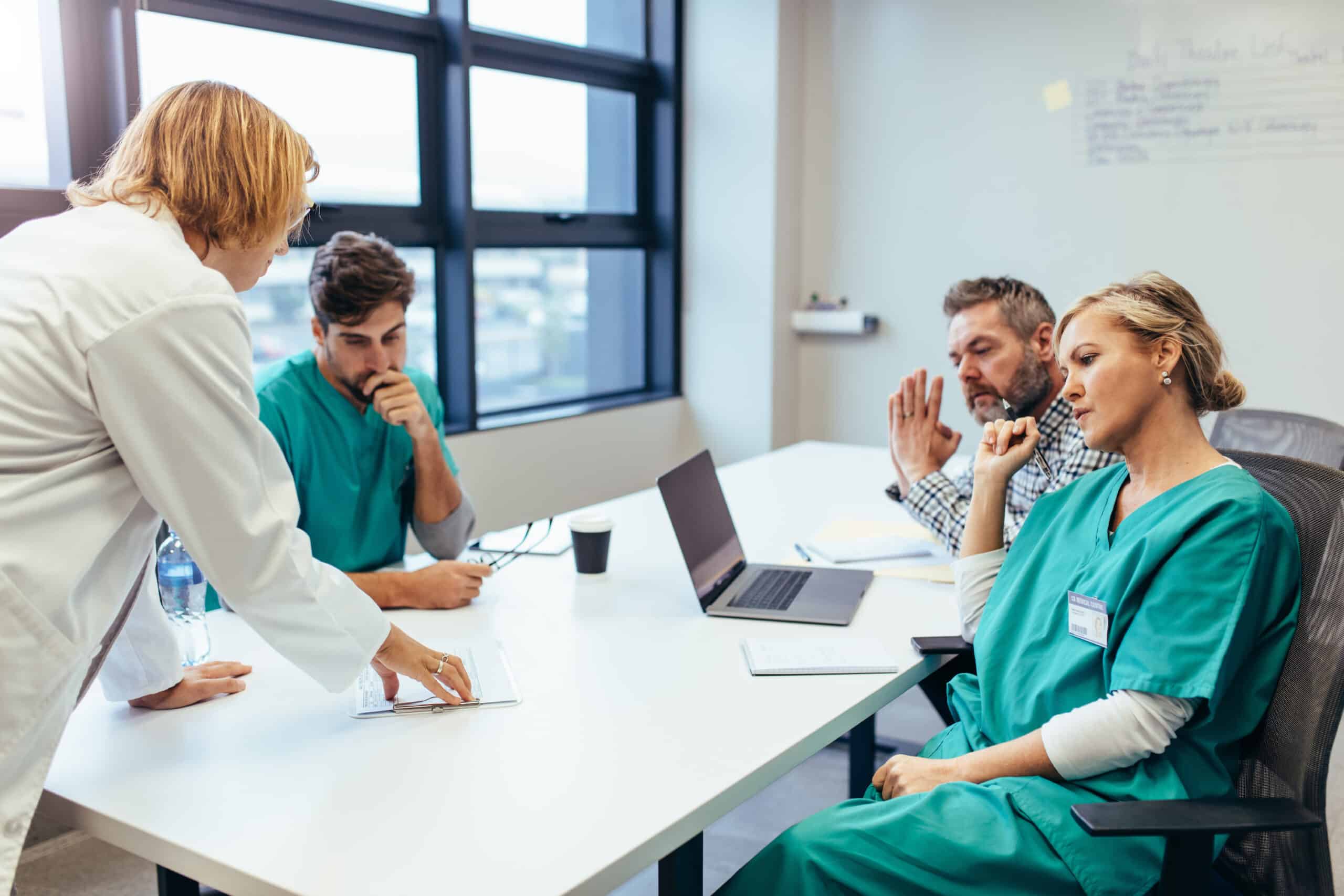 Medical professionals meeting at a conference table.