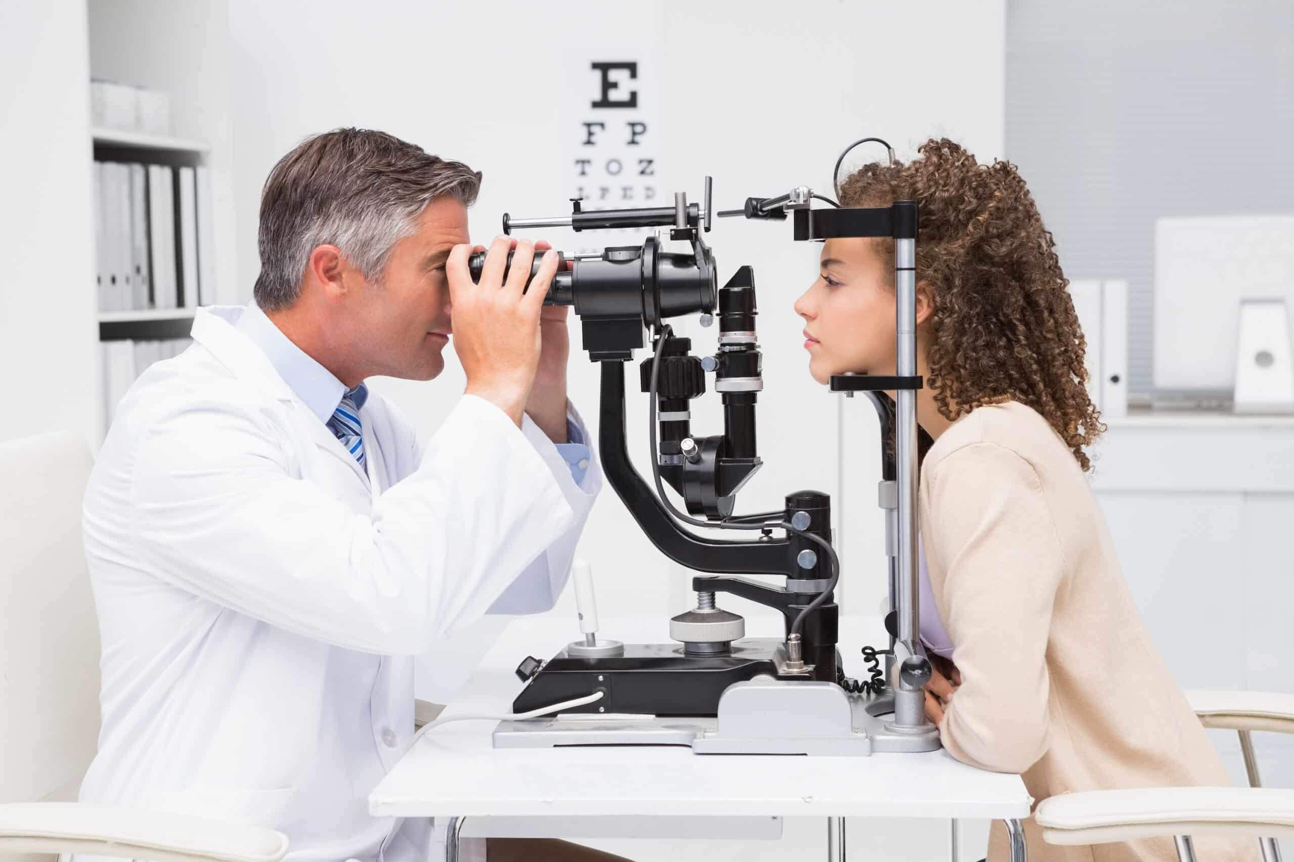 Ophthalmologist examines patient’s eye.
