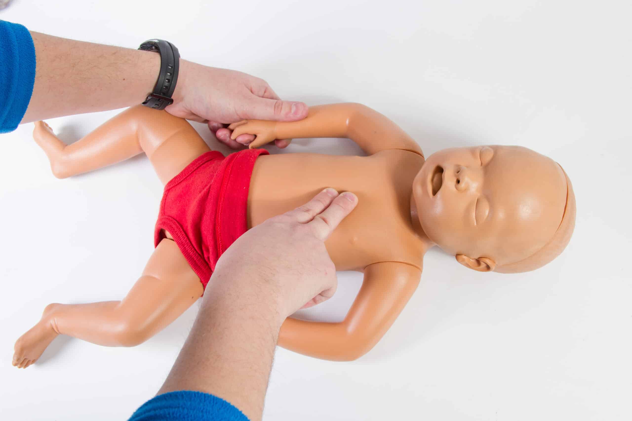 Lone rescuer performs 2-finger compressions on infant.