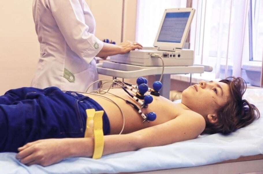 “Clinician administers ECG to child.”