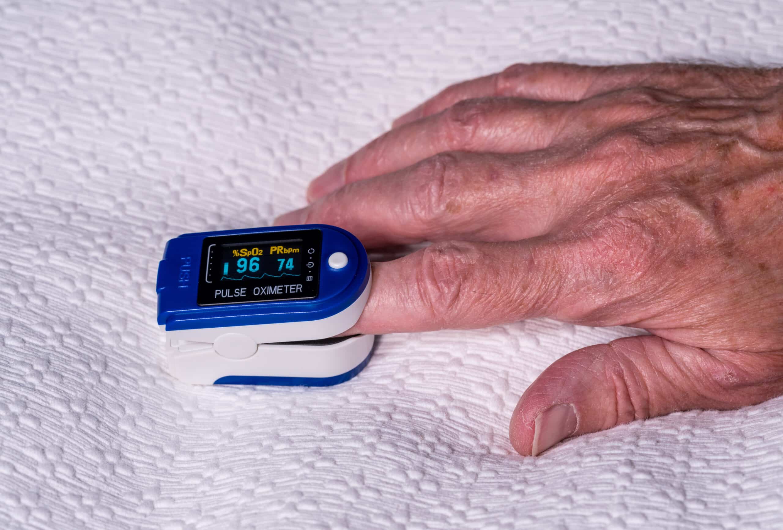 Measuring blood oxygen levels with a pulse oximeter on the patient’s finger.