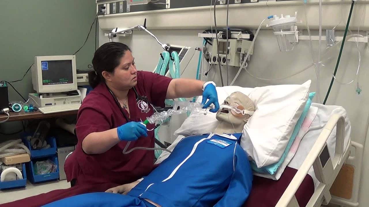 Closed suctioning of intubated patient using inline suction device.