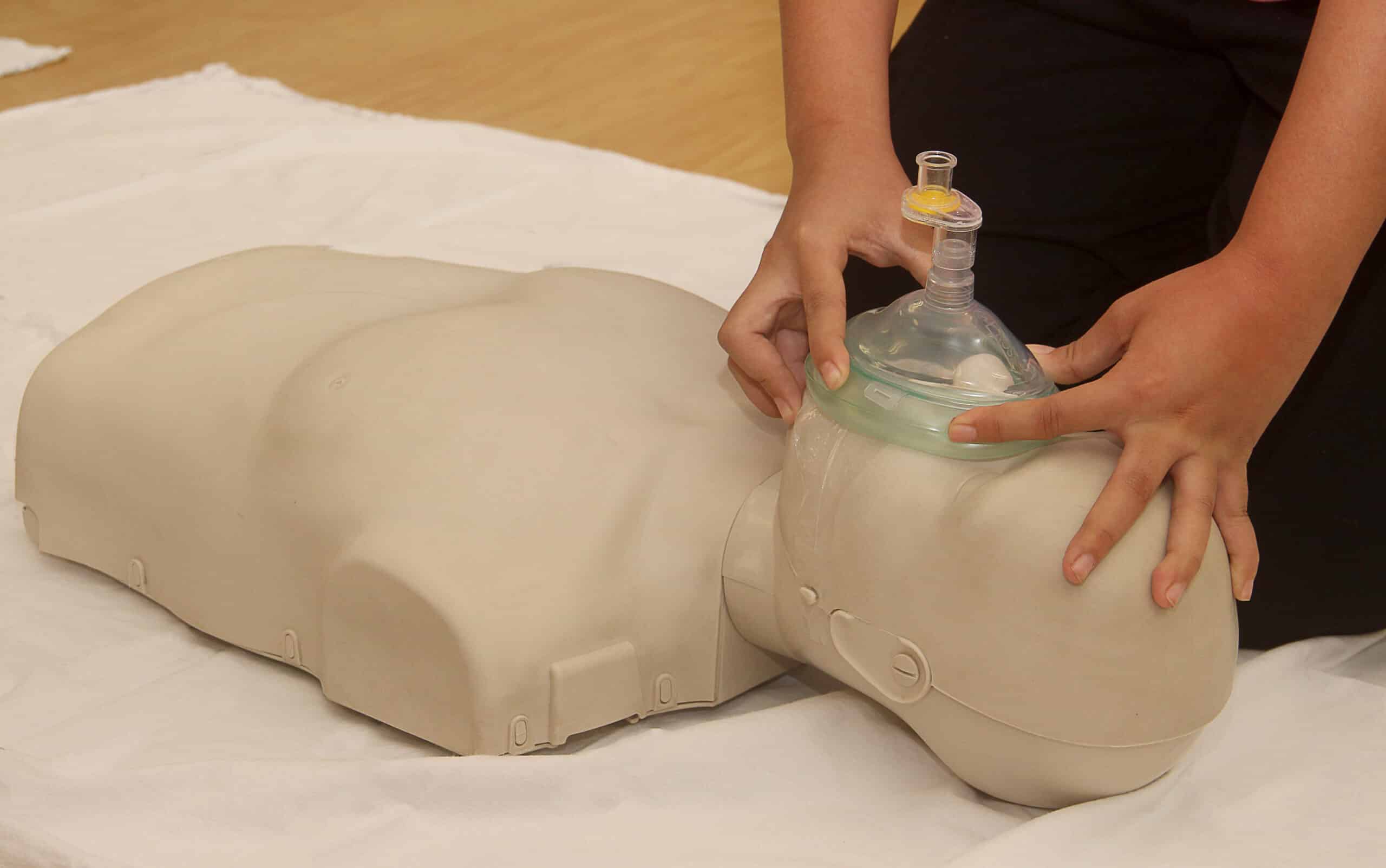 Demonstrating how to place a ventilation mask.