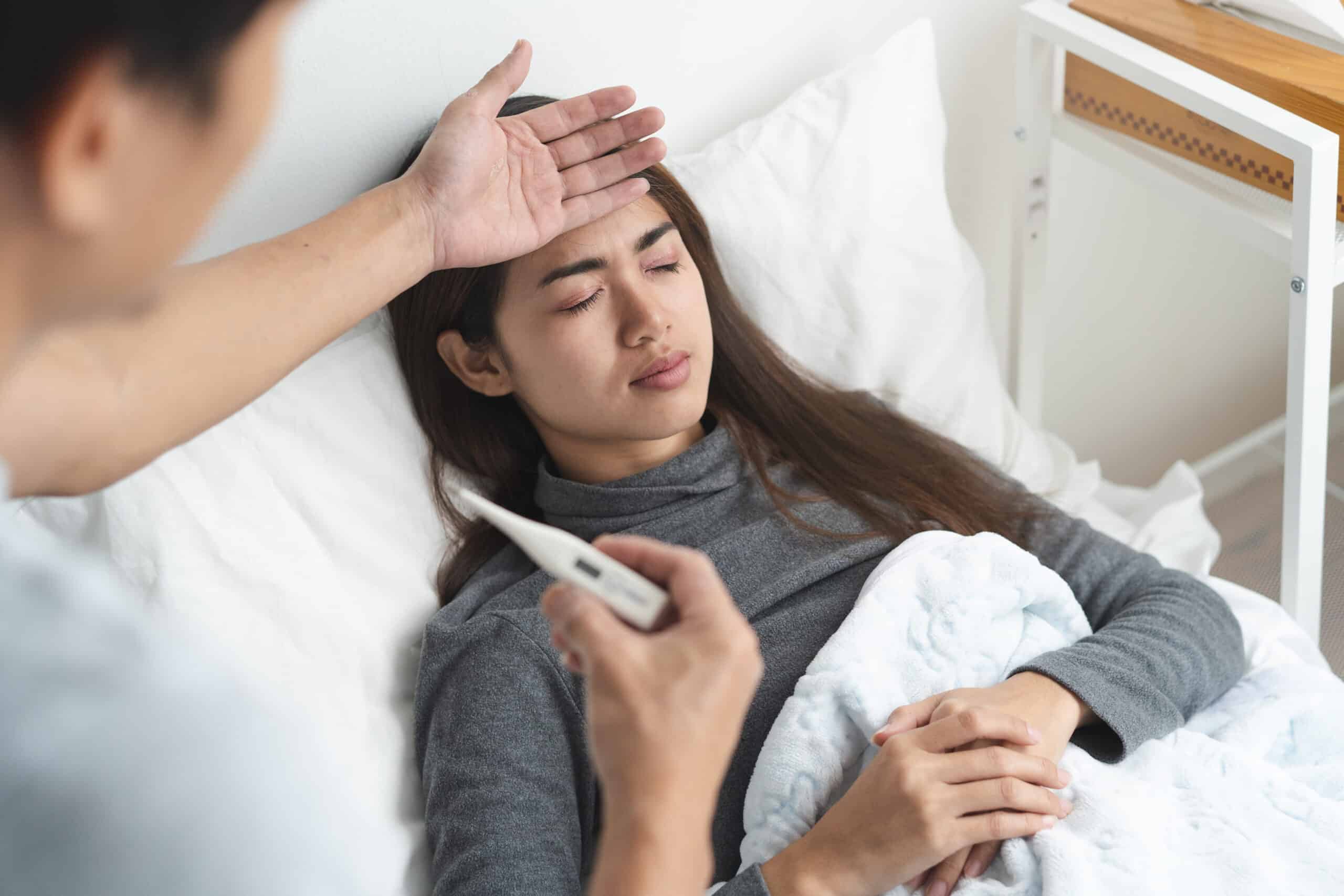 Provider assessing a patient for fever.