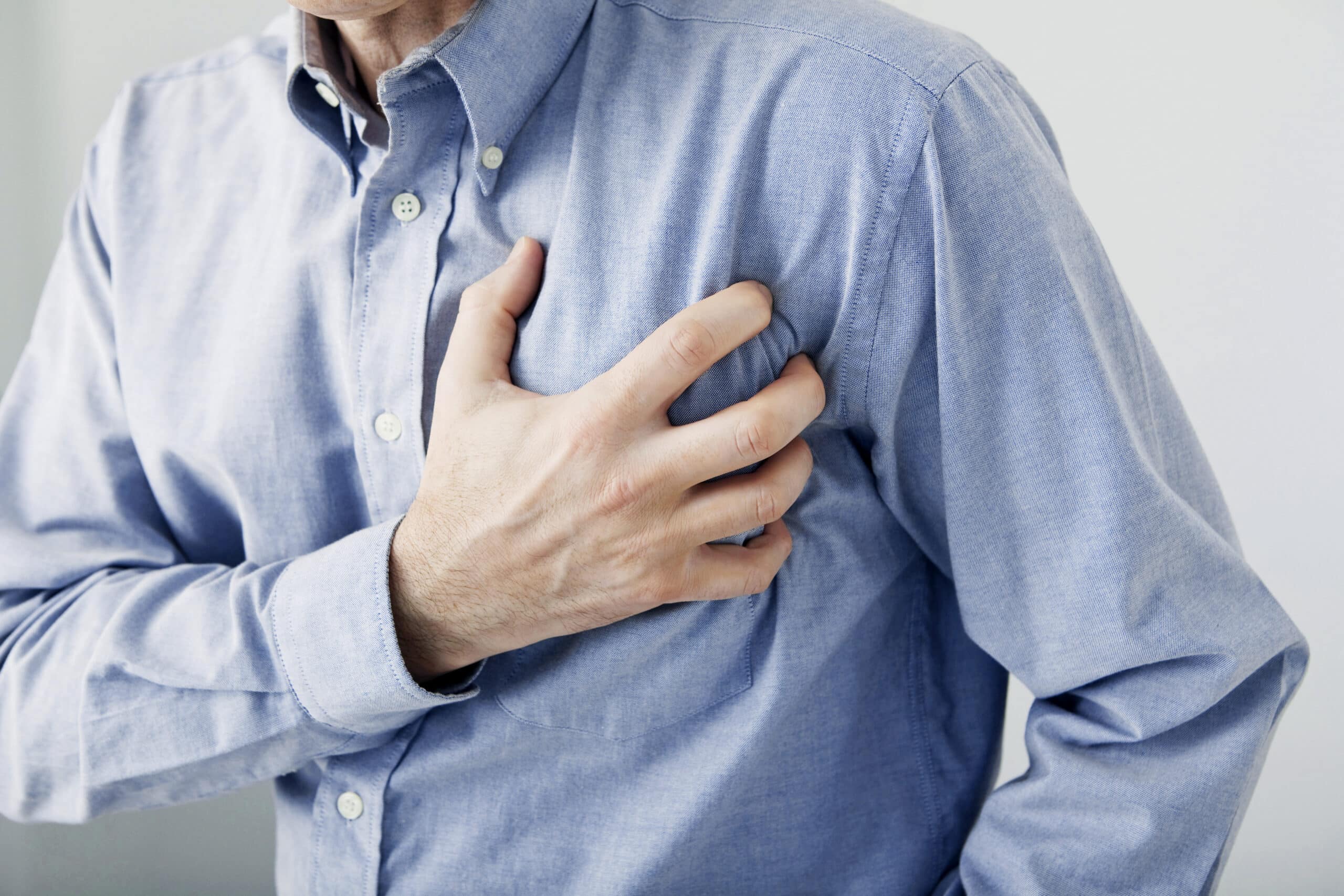 Person clutching chest in pain may indicate cardiac arrest.