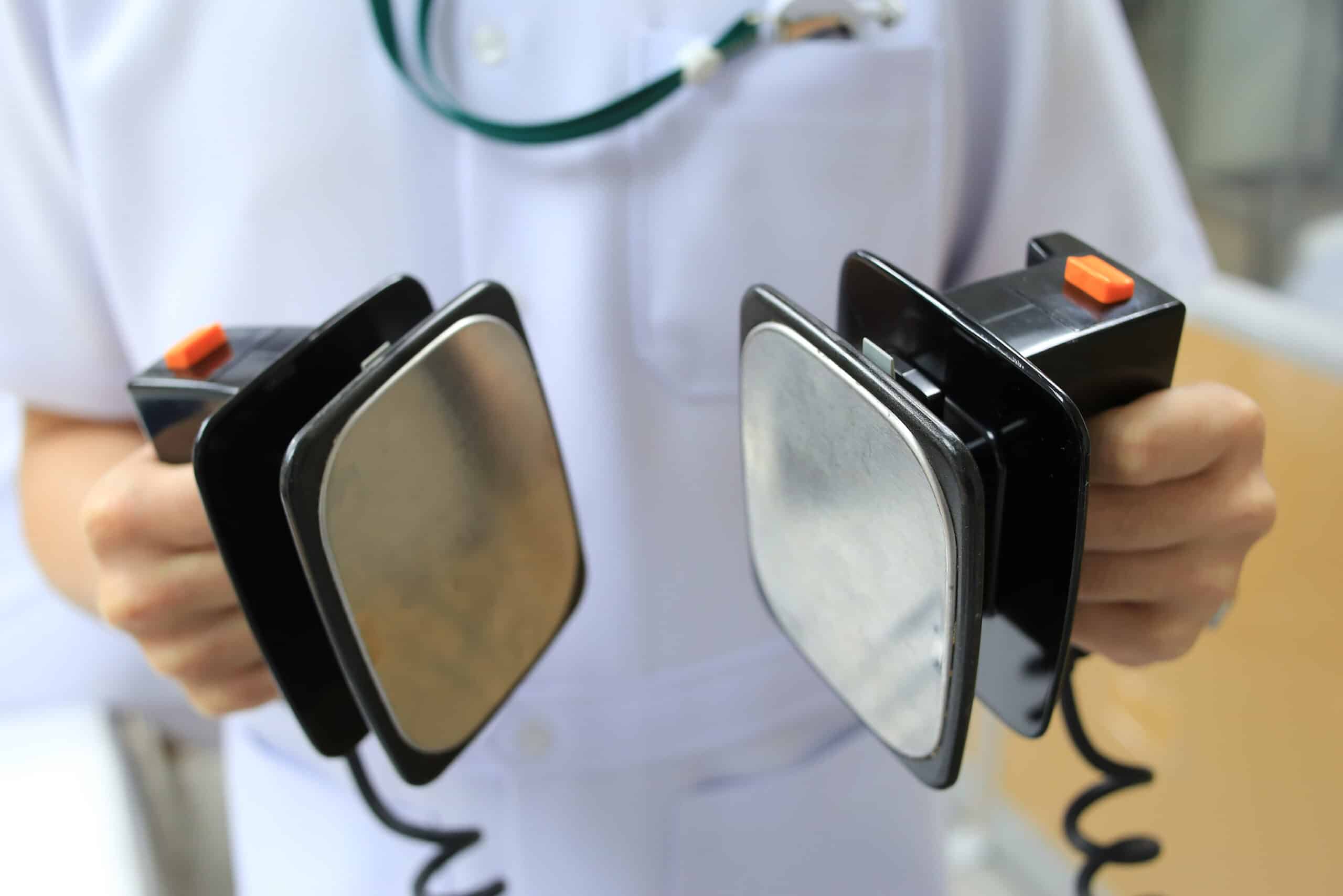 Person assuming defibrillator role.