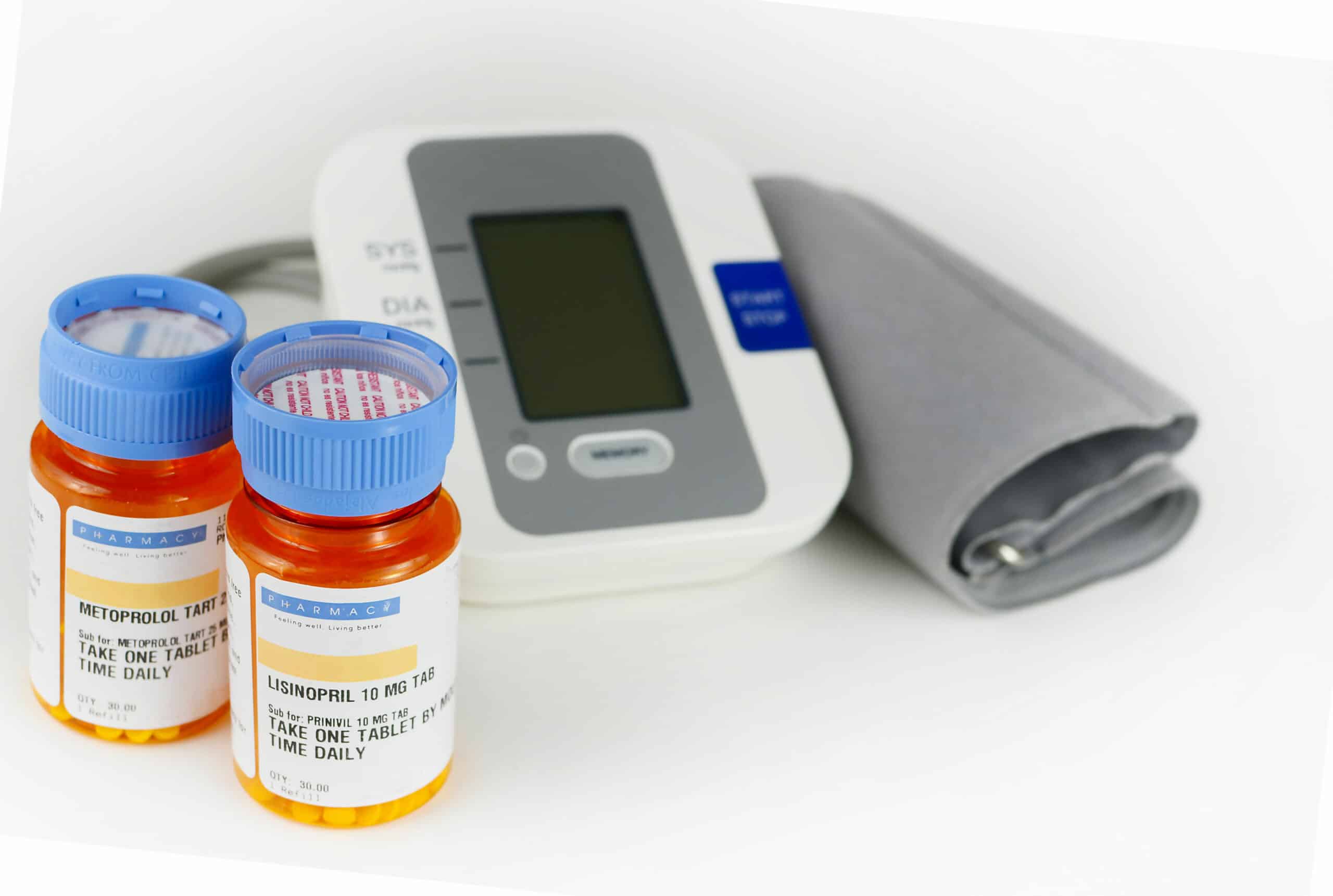 Lisinopril and metoprolol - bottles of medicine and a blood pressure cuff.