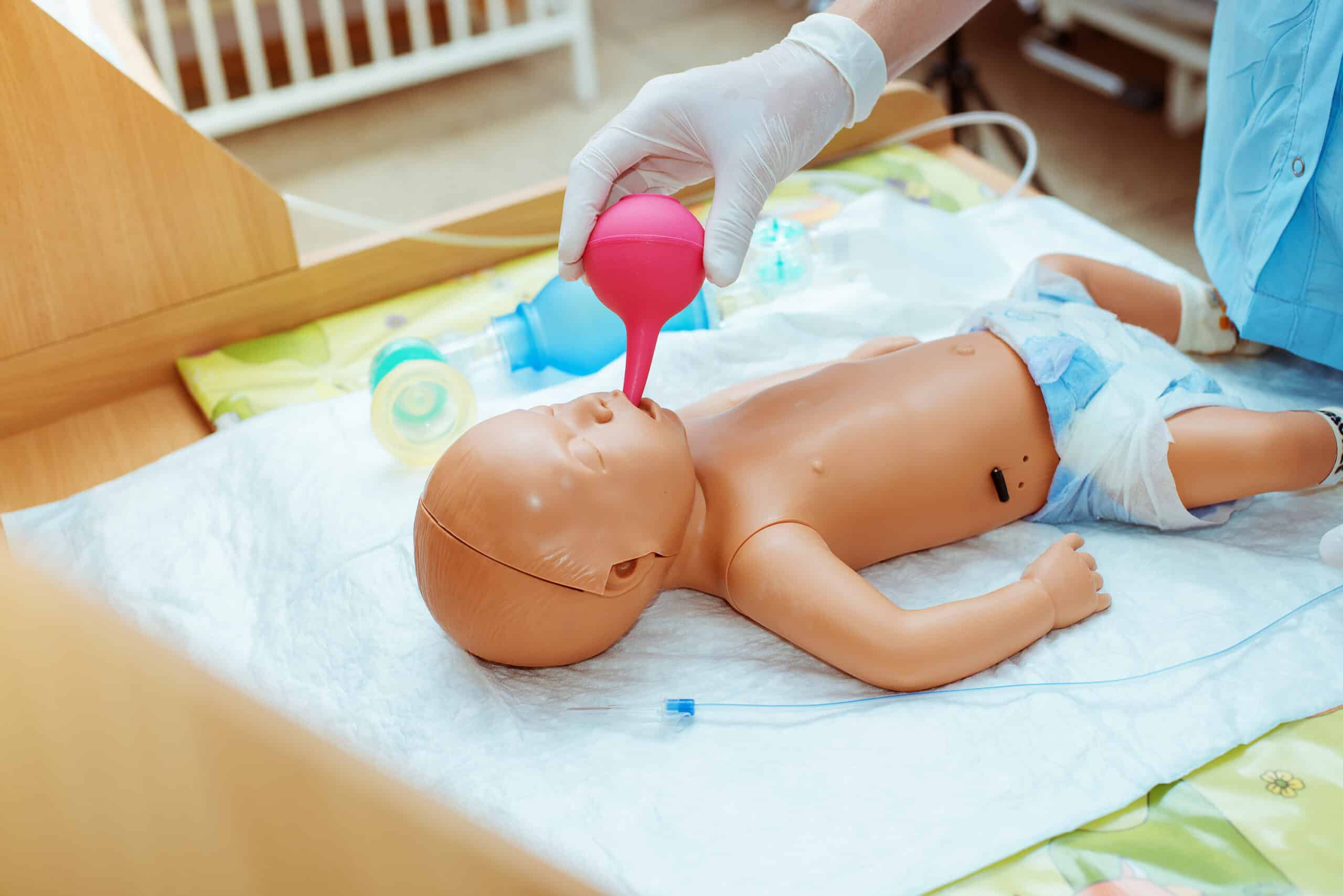 Clinician demonstrating how to use a bulb syringe.